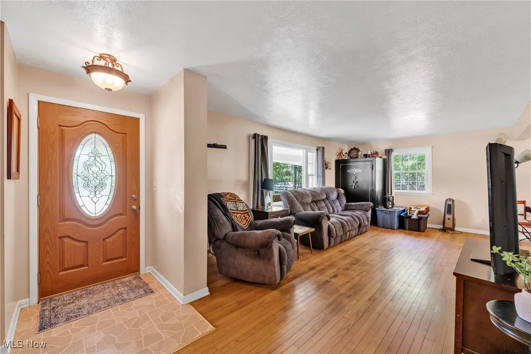 Foyer featuring hardwood floors and a textured ceiling