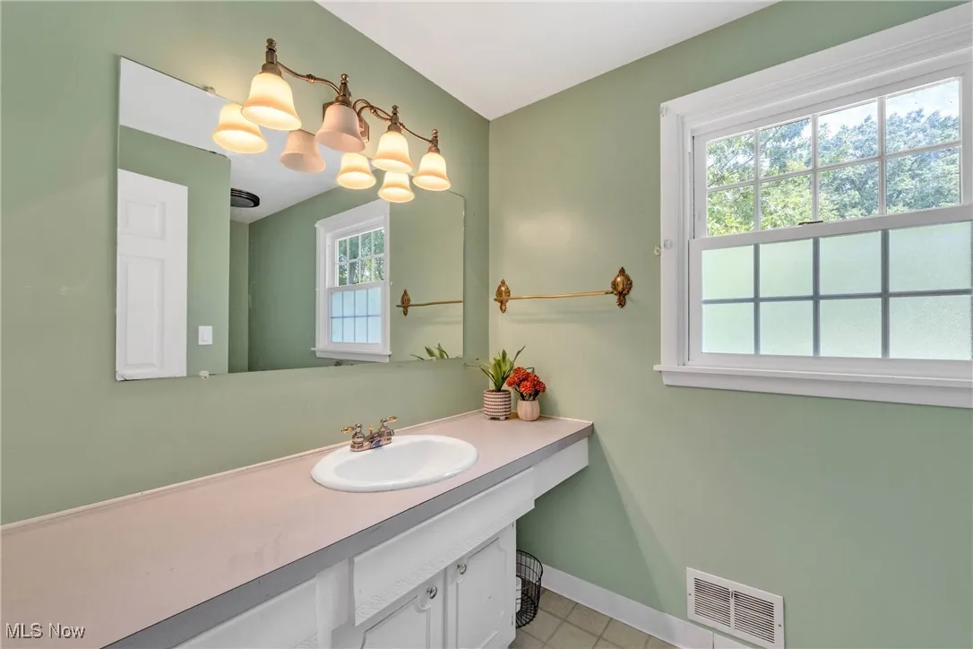Bathroom with vanity and light tile patterned floors