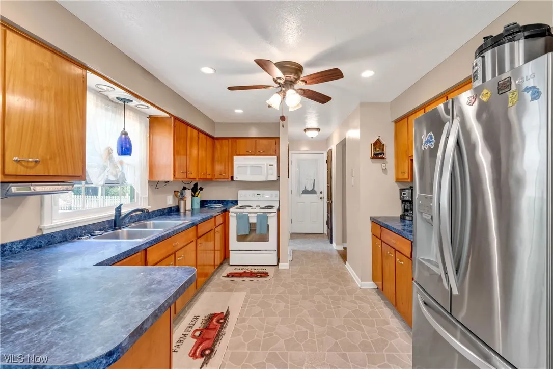Kitchen with ceiling fan and recessed lighting