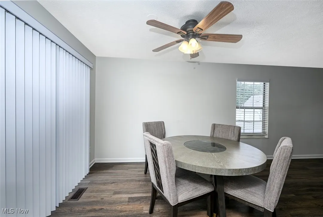Dining room with LVP, a textured ceiling, and a ceiling fan