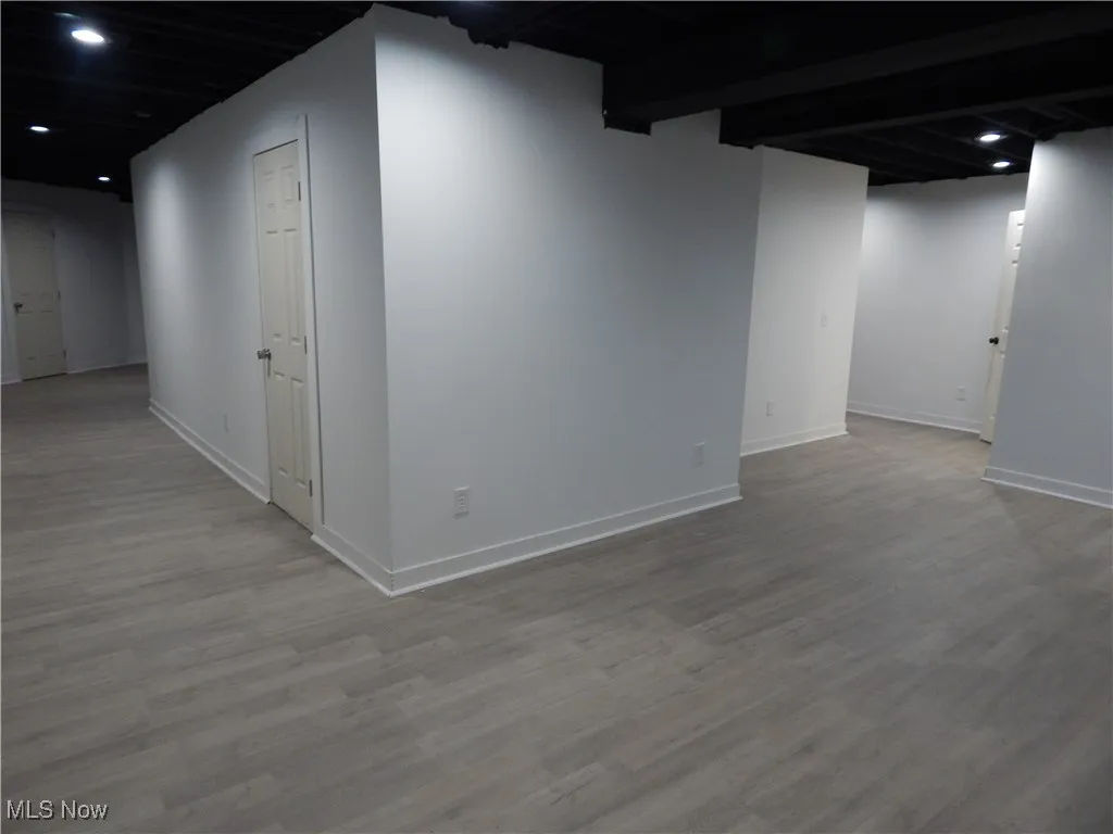 Finished basement featuring recessed lighting and light wood finished floors