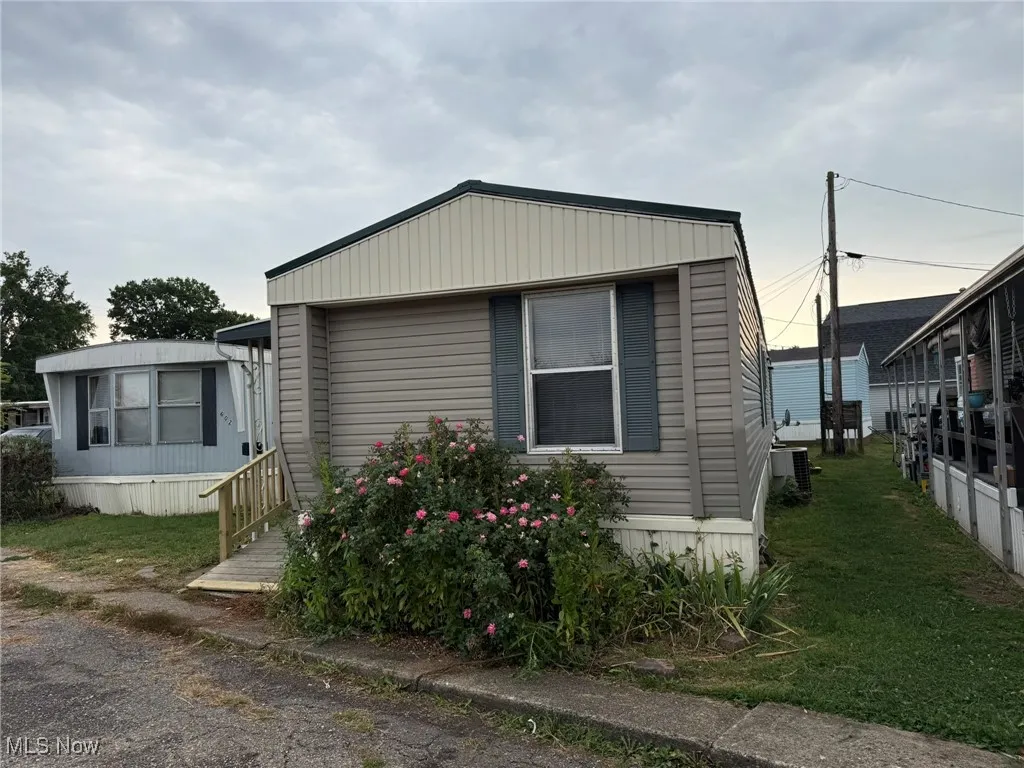 View of side of property featuring a yard
