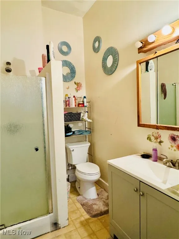 Bathroom with vanity and a stall shower