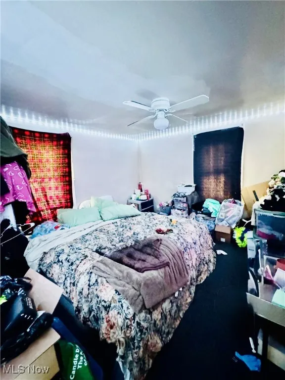 Bedroom featuring a ceiling fan and carpet floors
