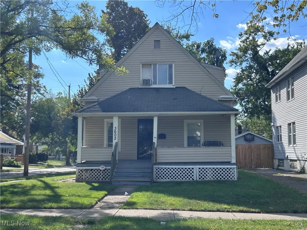 Bungalow-style house with a porch, a front yard, and roof with shingles