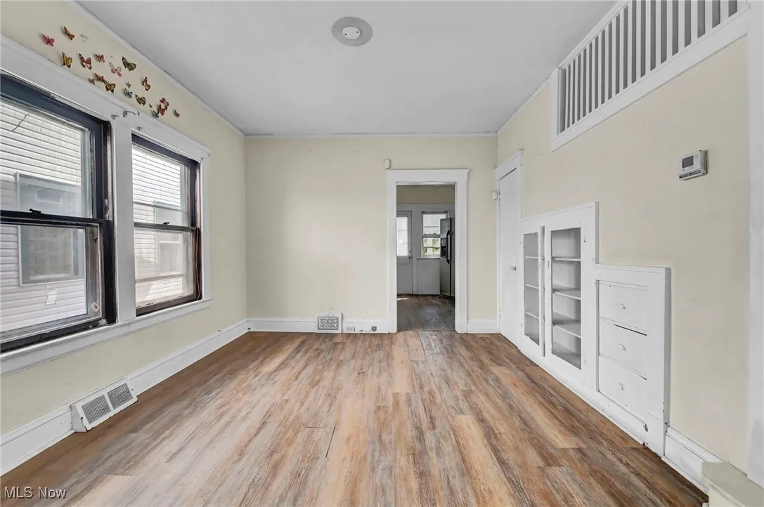 Spare room featuring wood finished floors and baseboards