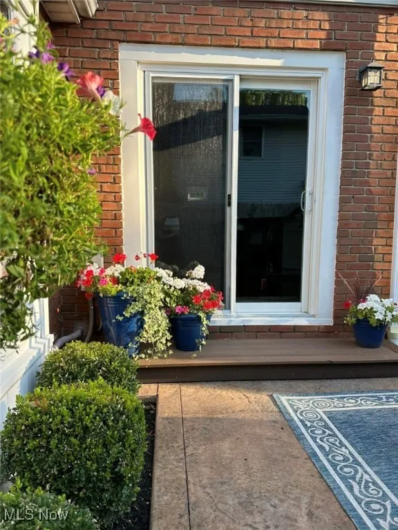 View of exterior entry featuring brick siding