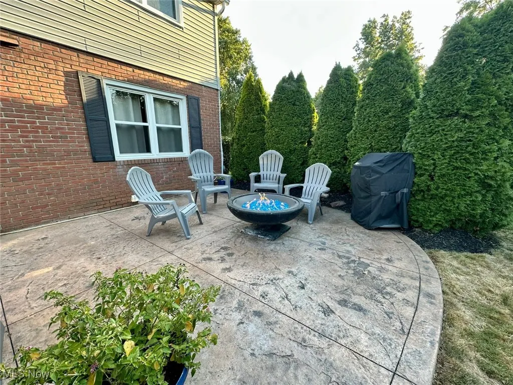 View of patio / terrace with a fire pit and area for grilling