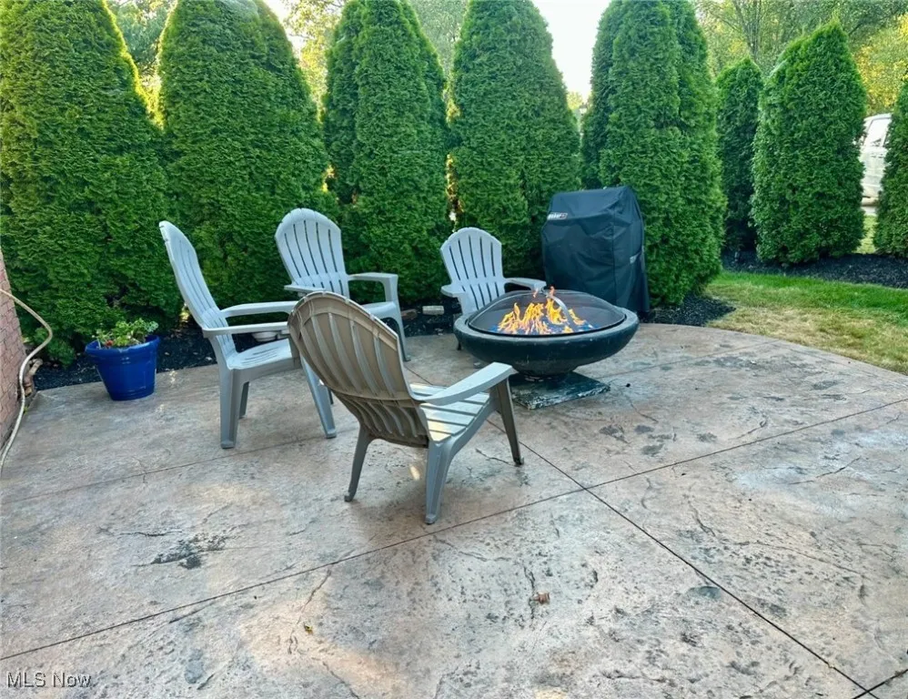 View of patio featuring a fire pit and grilling area