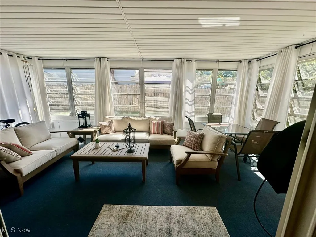 Sunroom featuring carpet floors