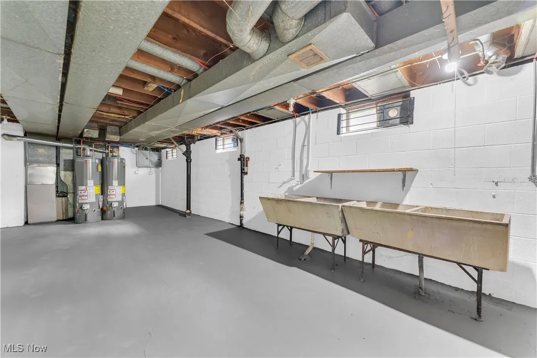 Basement featuring heating unit and gas water heater