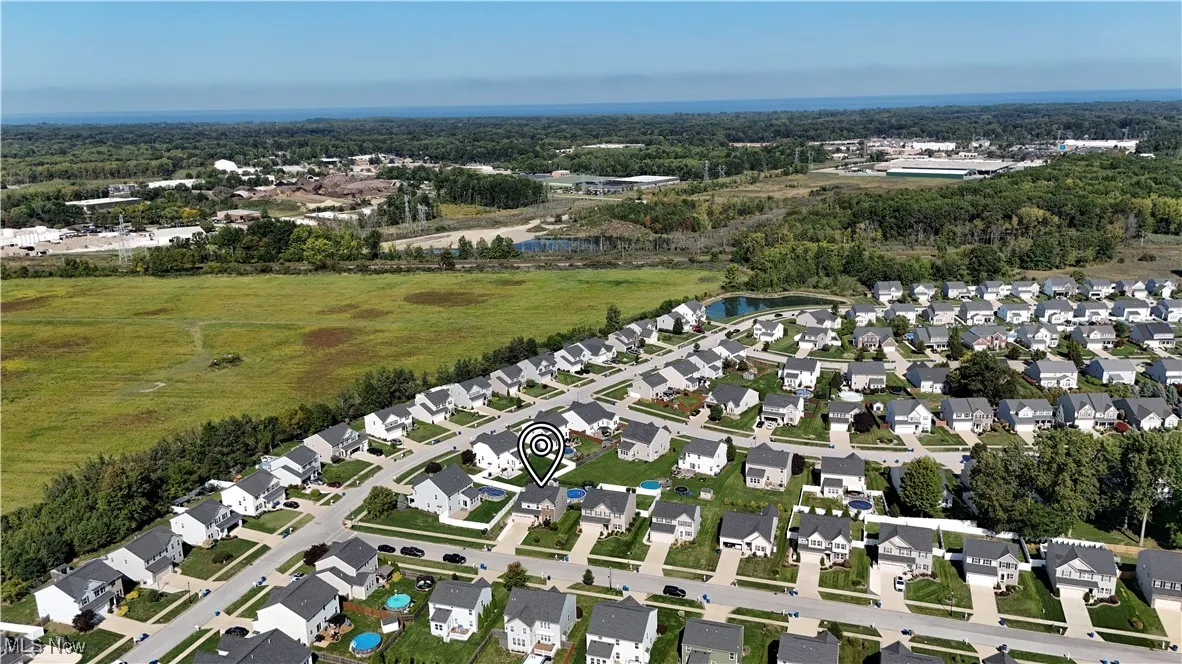 Aerial overview of property's location featuring nearby suburban area and a nearby body of water