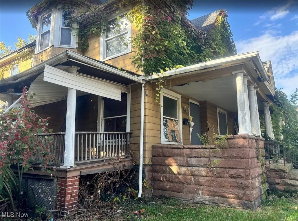 View of side of home featuring a porch