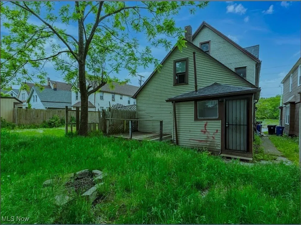 Back of house featuring a chimney