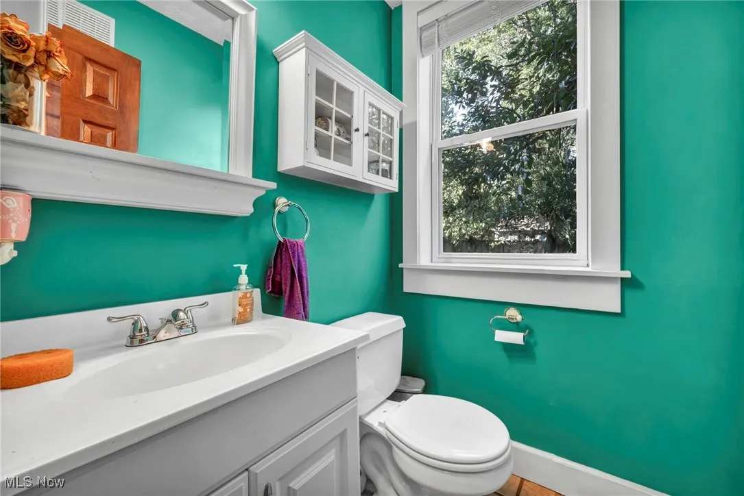 Half bath with plenty of natural light and vanity