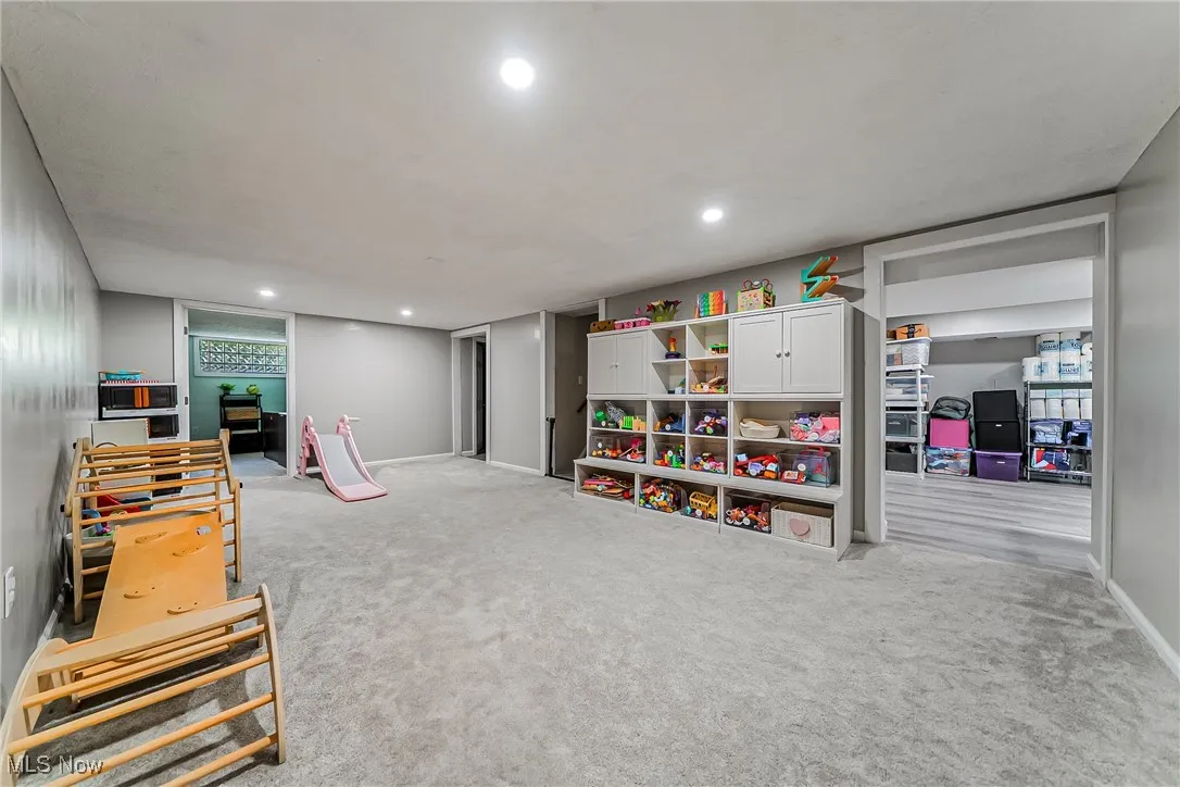 Recreation room featuring recessed lighting and light carpet