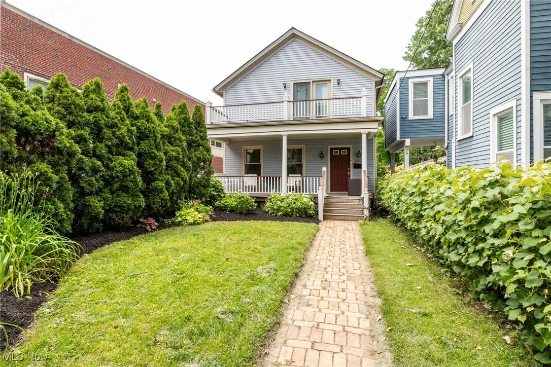 View of front of house with a porch and a front lawn