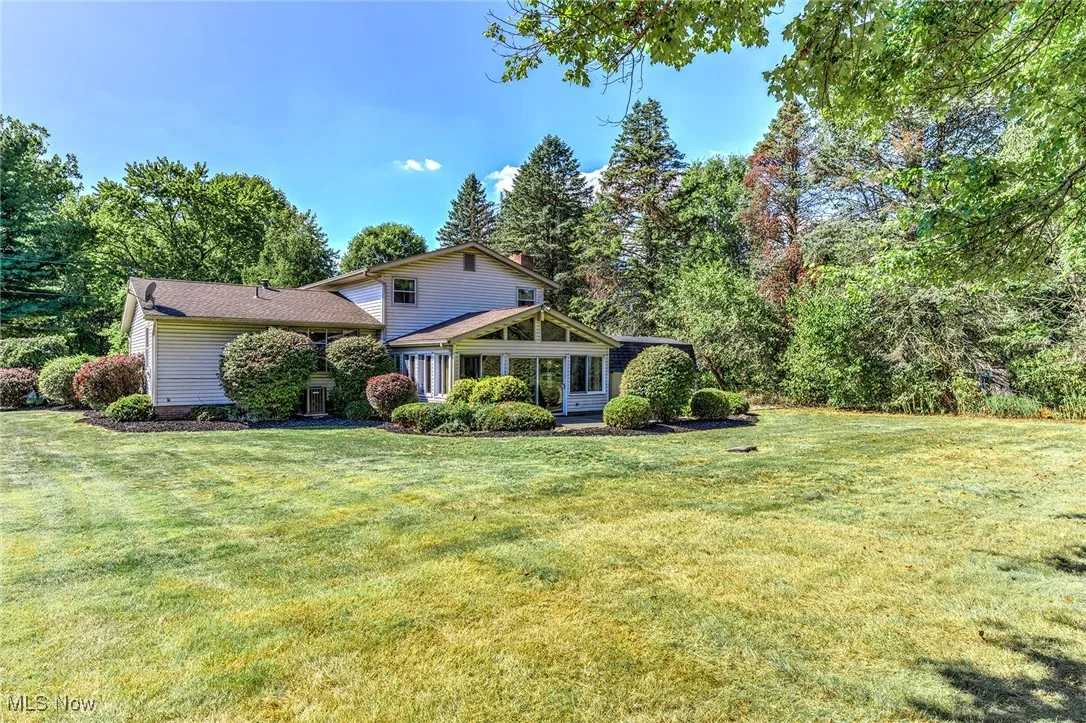 View of front of house featuring a front yard and a sunroom