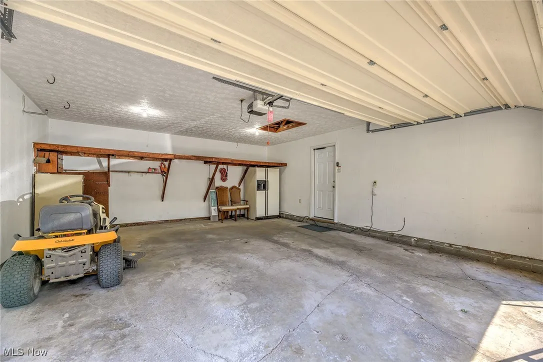 Garage featuring a garage door opener