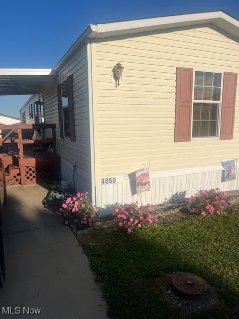 View of side of property featuring a deck