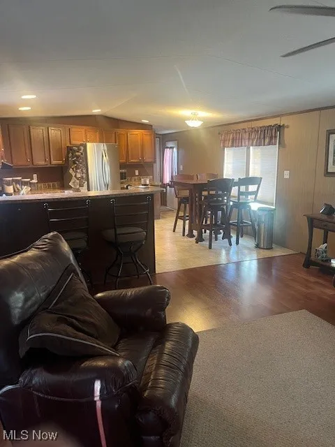 Living room with light wood-style flooring and ceiling fan