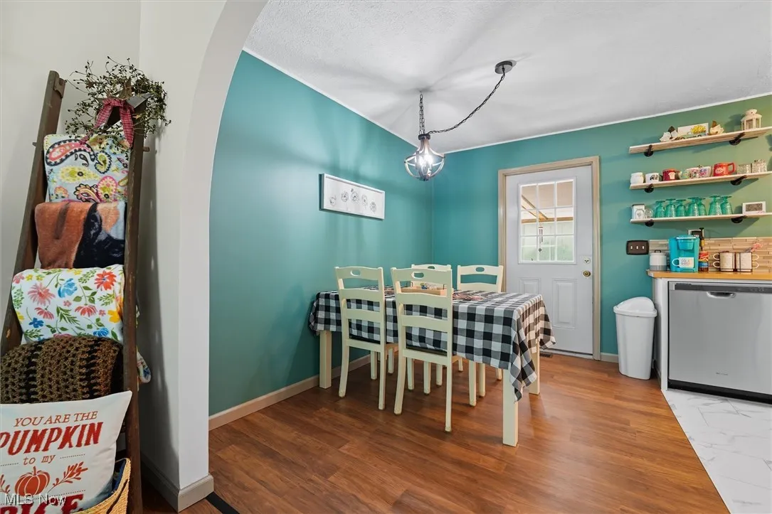 Dining space featuring wood finished floors and a textured ceiling