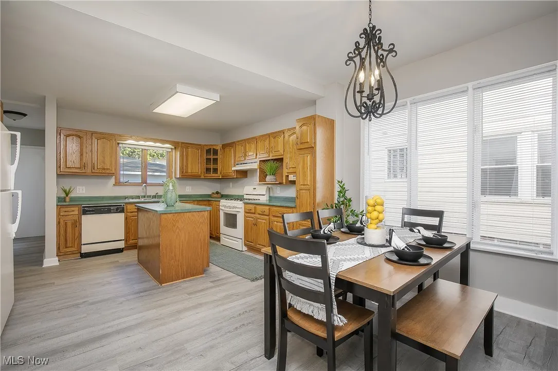 Dining space featuring light wood-type flooring and a chandelier
