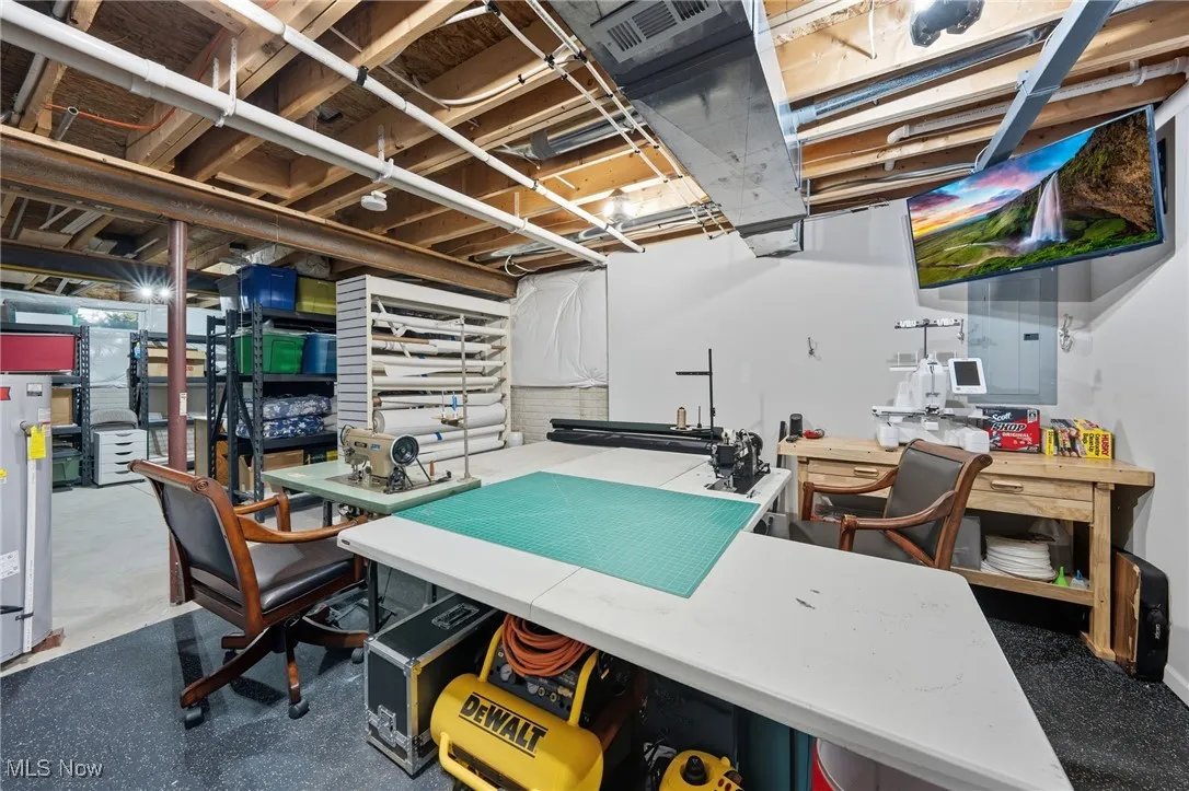 Office featuring water heater and a workshop area