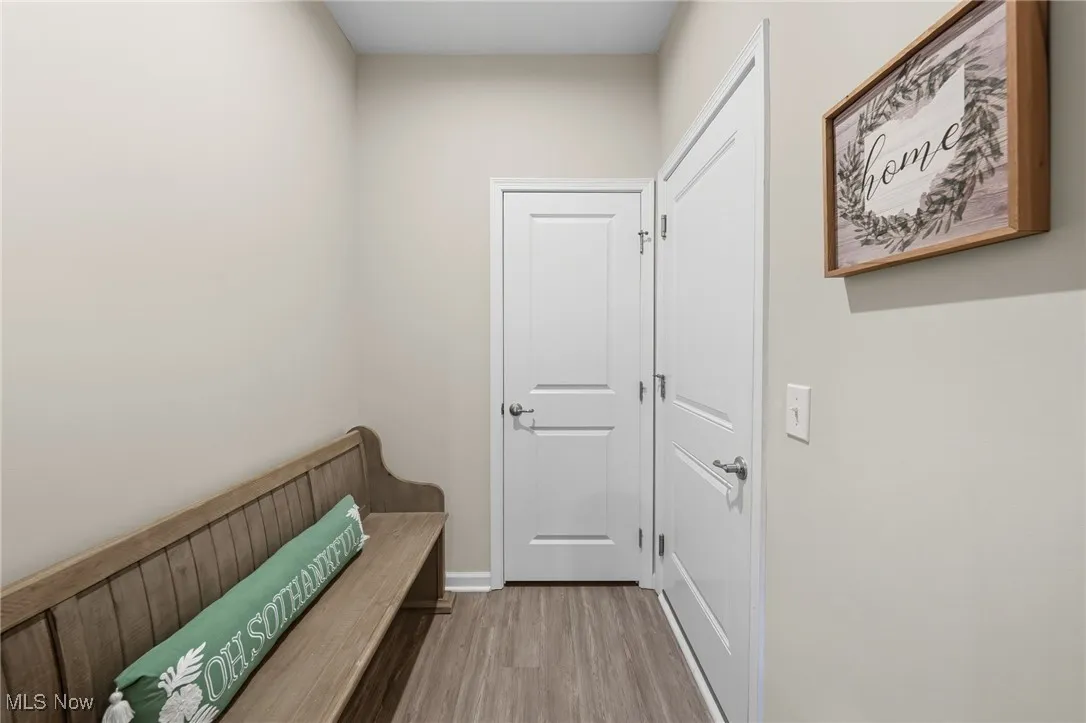 Mudroom with light wood finished floors and baseboards