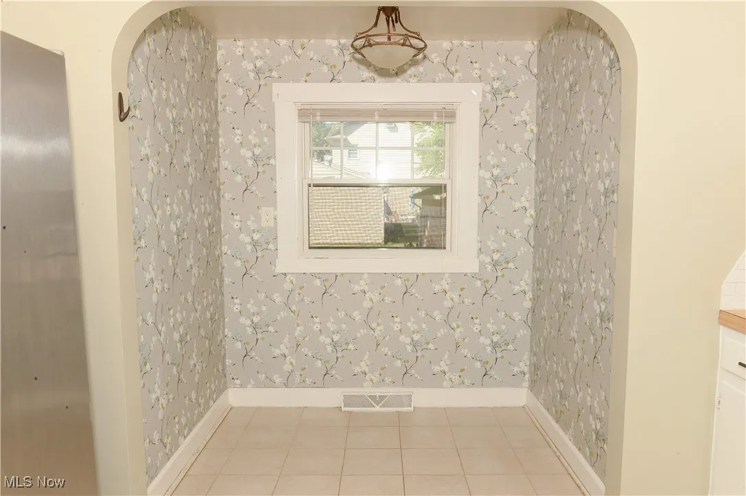 Detailed view of arched walkways and wallpapered walls