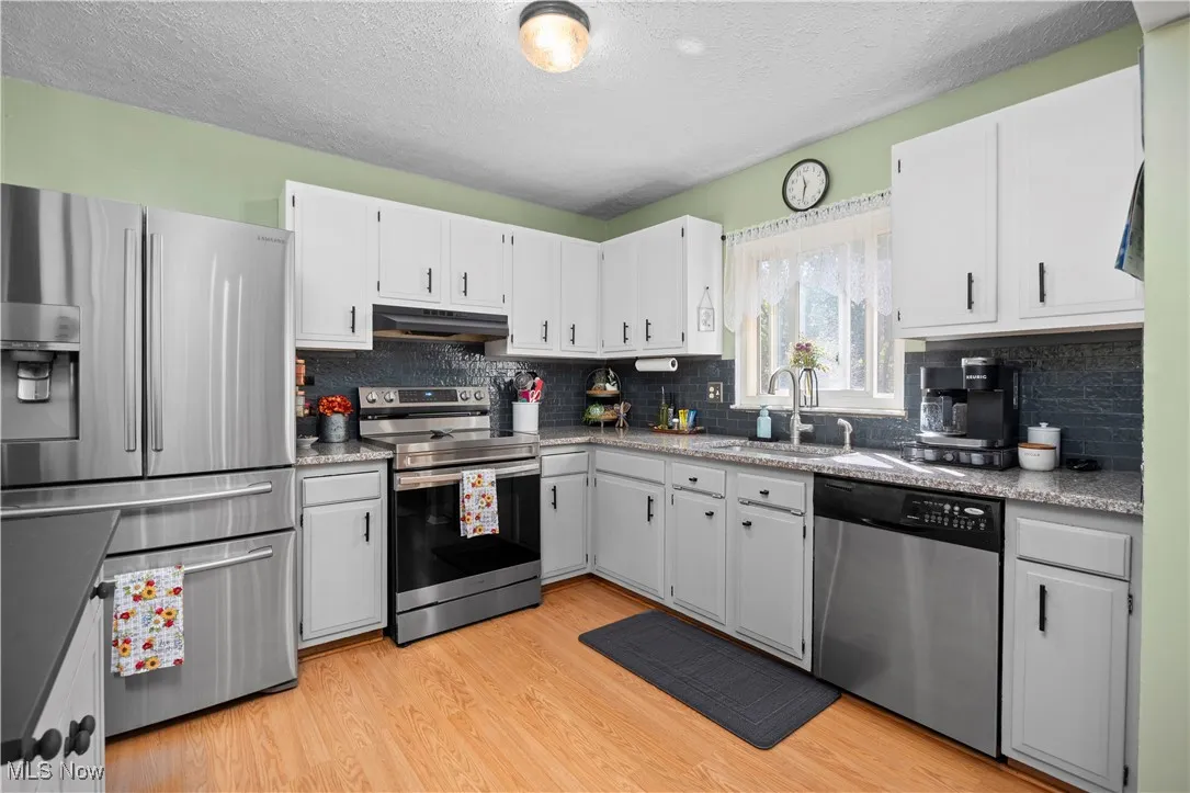 Granite countertops and chic black subway tile in the kitchen