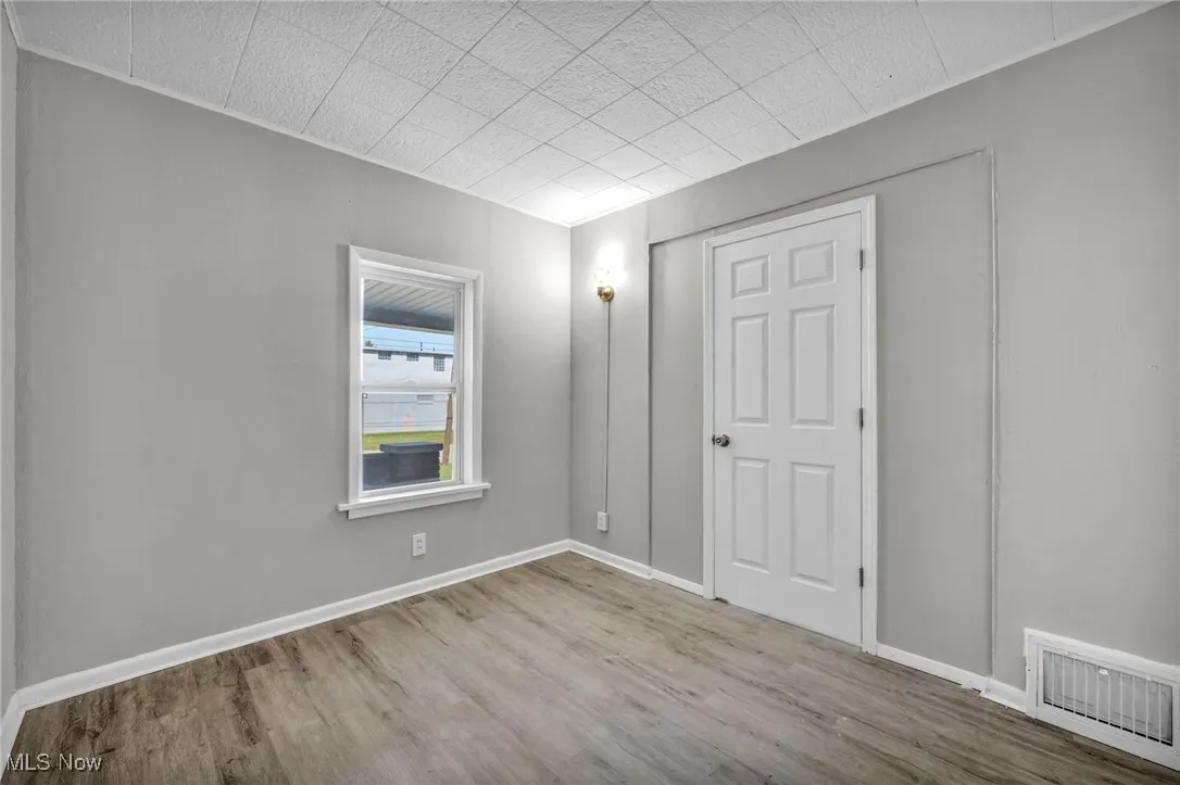 Unfurnished bedroom featuring wood finished floors