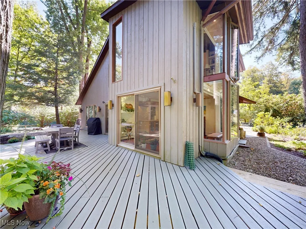 Wooden deck with outdoor dining area and area for grilling