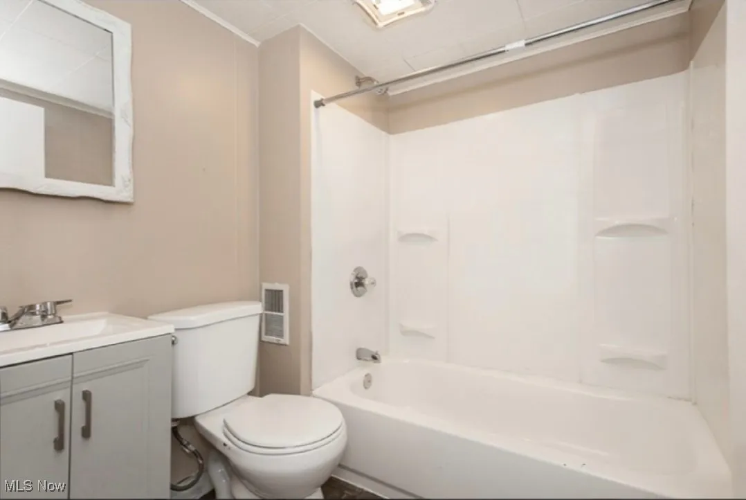 Full bathroom with shower / bath combination and vanity