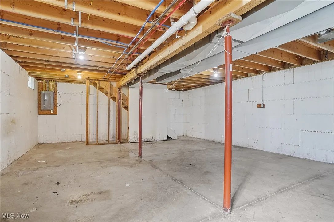 Unfinished basement with electric panel