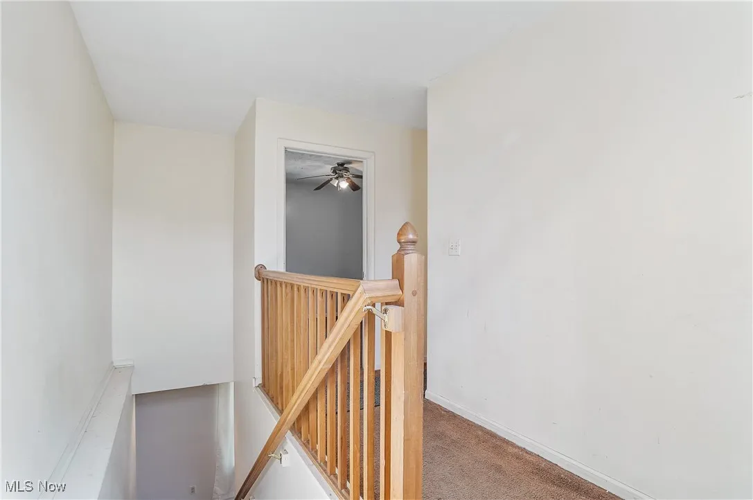 Staircase featuring carpet and baseboards