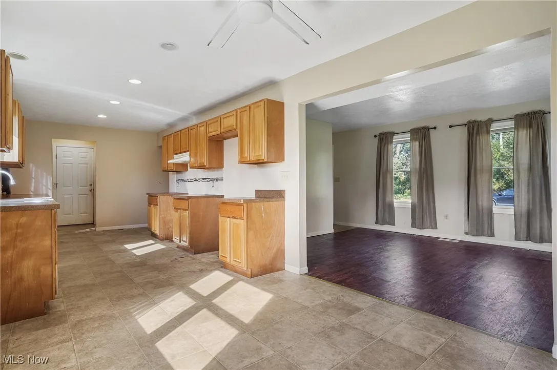 Kitchen featuring ceiling fan, recessed lighting, and brown cabinetry