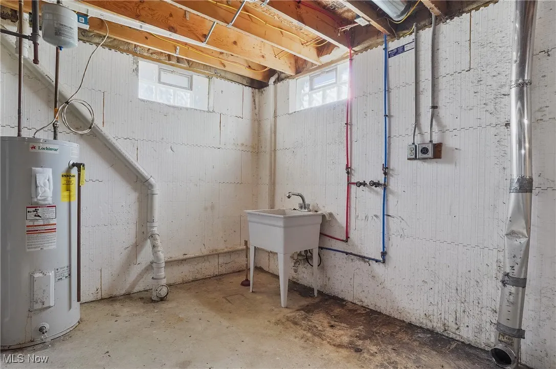 Below grade area featuring water heater