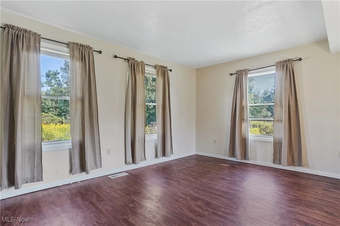 Spare room with wood finished floors and baseboards