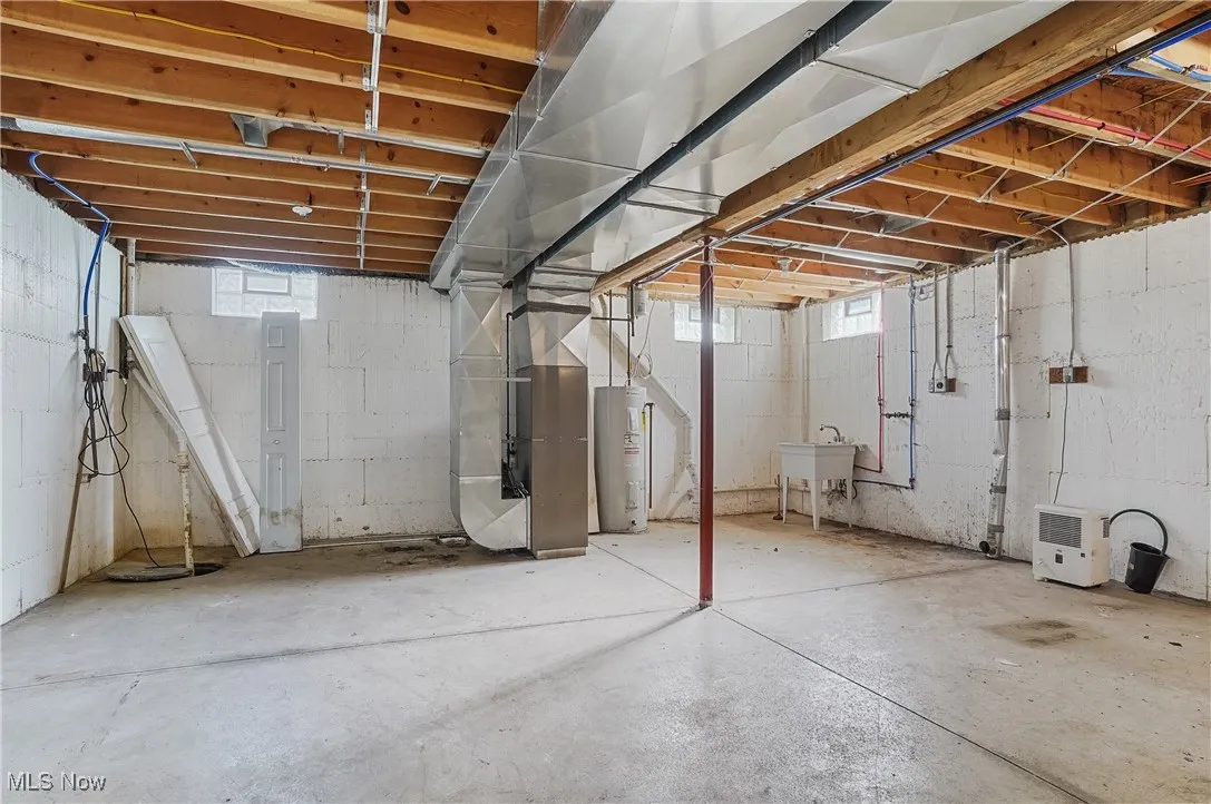 Basement with heating unit and electric water heater