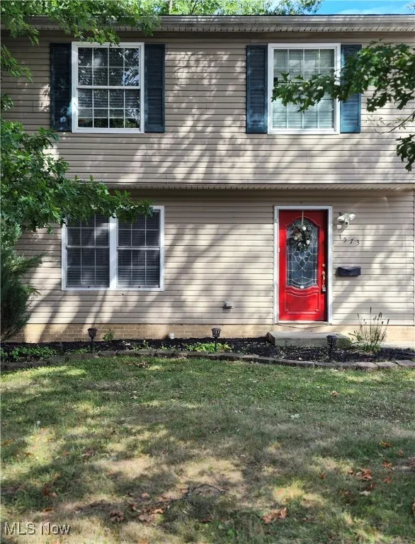 Colonial inspired home featuring a front lawn