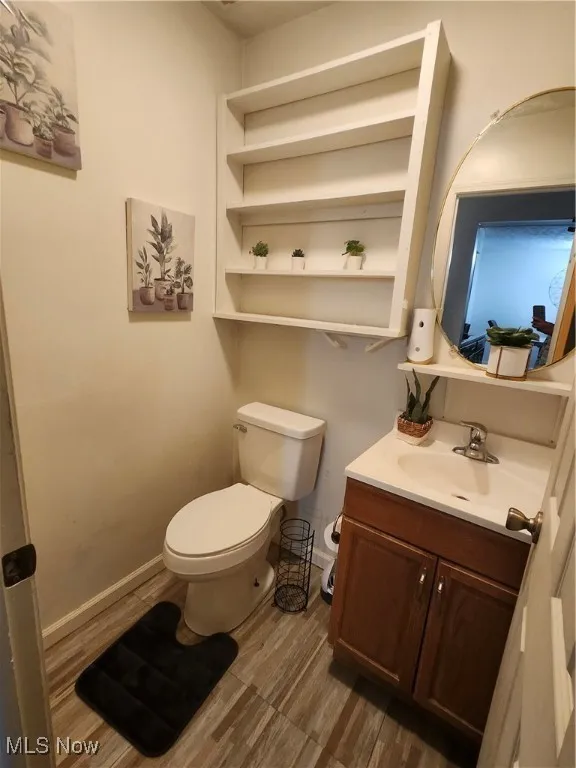 Half bathroom with vanity and toilet