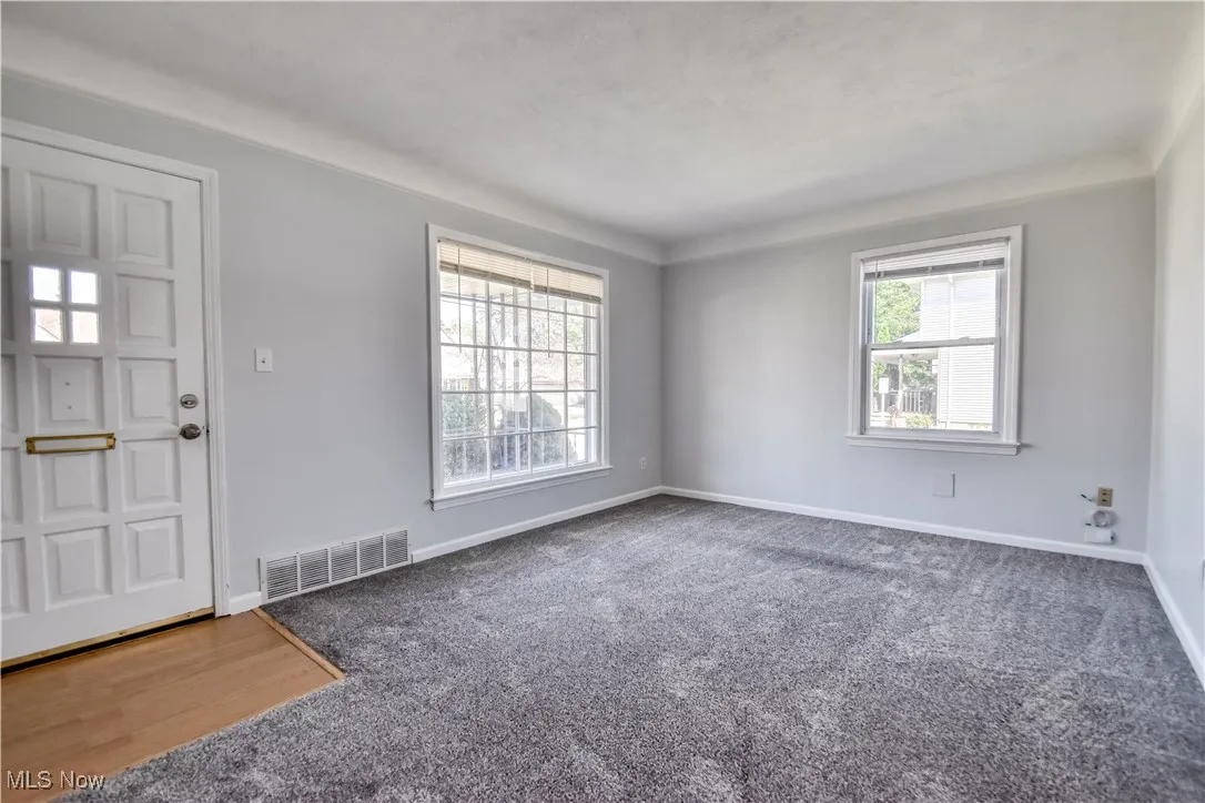 Another angle of the living room showing front door