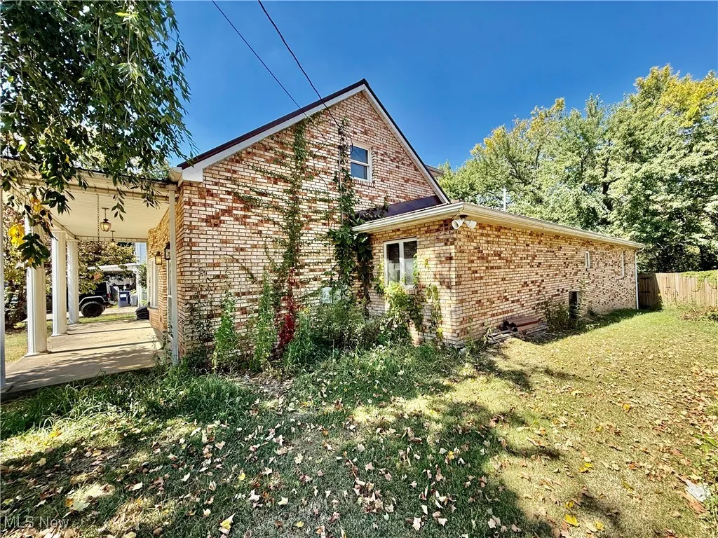 Back of house featuring brick siding
