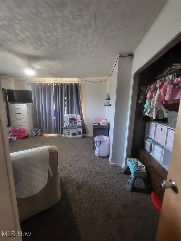Bedroom with carpet floors and baseboards