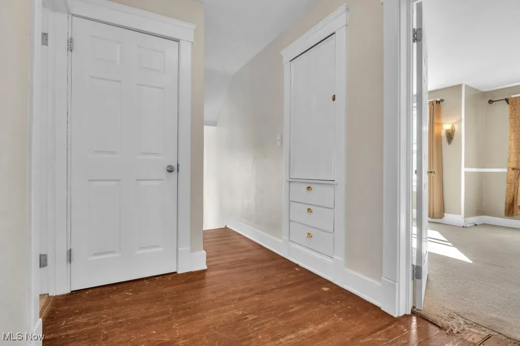 Hall with dark wood-style flooring