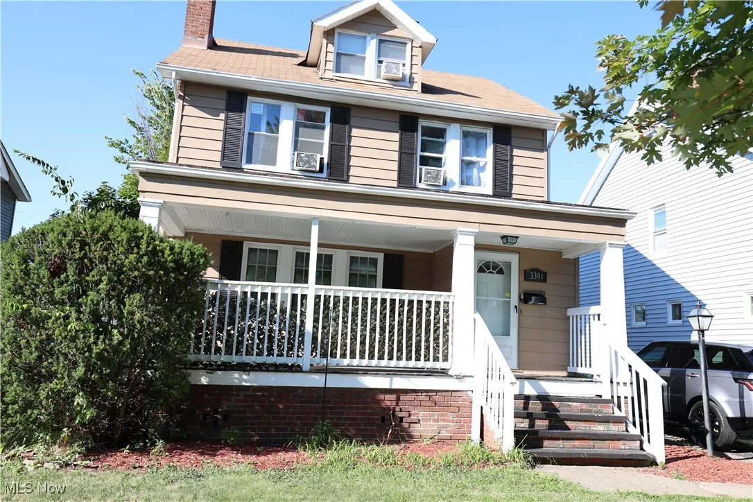 Colonial style home with a large front porch