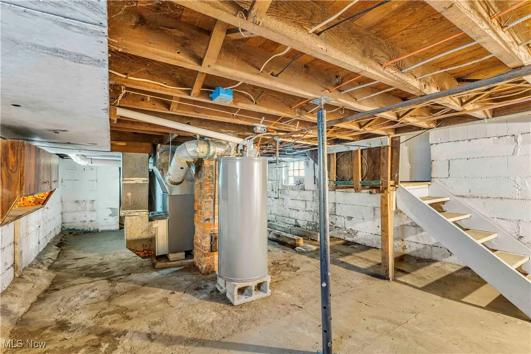 Basement featuring water heater and heating unit