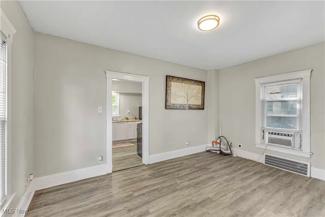 Unfurnished room with light wood-style floors and baseboards