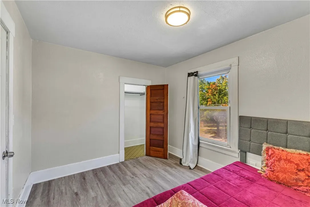 Bedroom featuring wood finished floors and a closet
